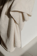 Takasa undyed organic and Fairtrade Cotton towel on a bath tub