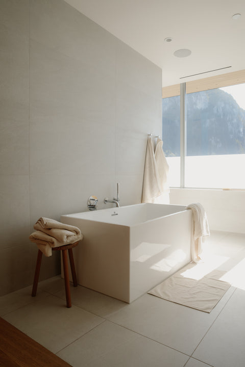 Natural bath towels in a beautiful bathroom overlooking the mountains. Towels made with Fairtrade Cotton  by Takasa
