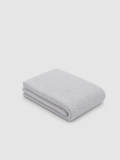 Folded Mist grey towel on a light grey background
