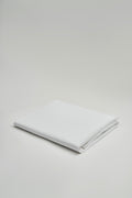 Folded white fabric on a light gray background