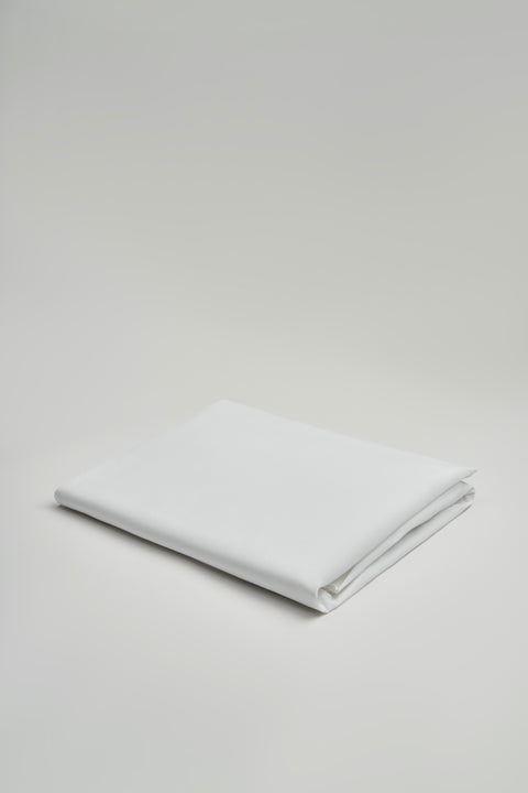 Folded white fabric on a light gray background