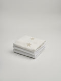 Organic and Fairtrade Cotton Crib Sheet and Muslin Wrap Set in White with Stars#color_white-stars
